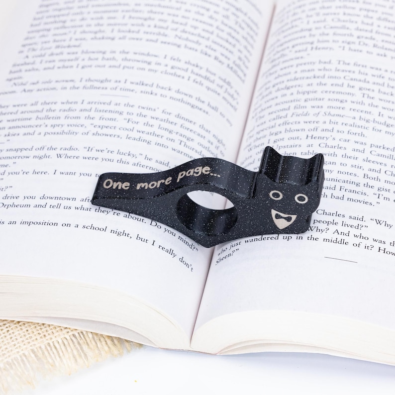 Black tuxedo cat thumb book page holder with bookmark, ergonomic and playful design, perfect gift for book lovers, adds charm to reading, ideal for birthdays, anniversaries, or as a stocking stuffer, a practical and adorable reading companion