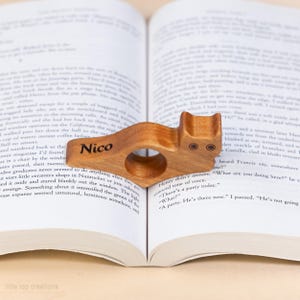 Cherry hardwood cat thumb book page holder with bookmark, ergonomic and playful design, perfect gift for book lovers, adds charm to reading, ideal for birthdays, anniversaries, or as a stocking stuffer, a practical and adorable reading companion