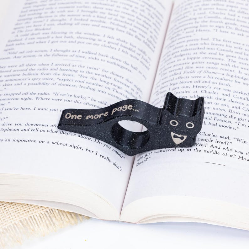 Black tuxedo cat thumb book page holder with bookmark, ergonomic and playful design, perfect gift for book lovers, adds charm to reading, ideal for birthdays, anniversaries, or as a stocking stuffer, a practical and adorable reading companion