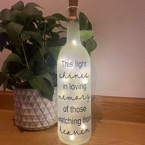 This light shines in loving memory of those watching from heaven. Lighted wine bottle, wedding memorial, In memory of, wedding tribute