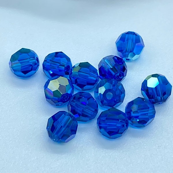 Swarovski® 5000 Capri Blue AB 6mm - Swarovski Crystals Capri Blue AB 6mm - un paquet de 11 pièces, 8 paquets de 12 pièces disponibles.