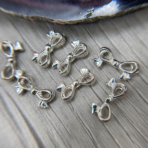 Silver bow beads, Bows, 15.5 x 8mm Silver bows, Light weight, bows for cube beads, Bows, holiday beads. Only one pack left.