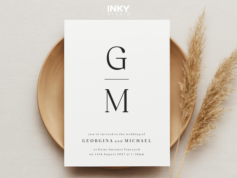 May include: A white wedding invitation with black text. The invitation features the couple's initials, "G" and "M", and the text "you're invited to the wedding of GEORGINA and MICHAEL at Saint Antonio Vineyard on 14th August 2027 at 1:30pm."