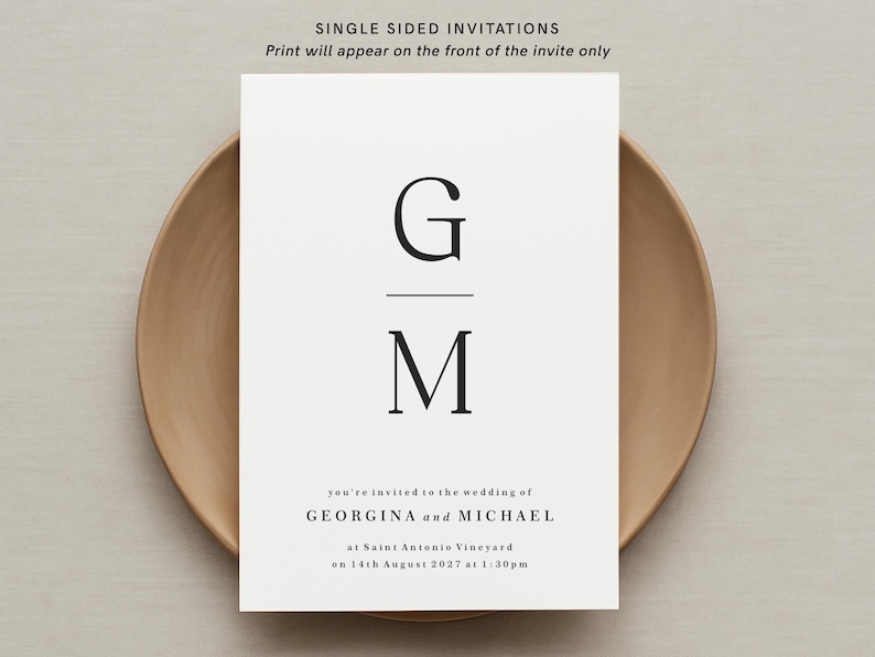 May include: A minimalist wedding invitation with the initials "G" and "M" in a black serif font. The text reads "you're invited to the wedding of GEORGINA and MICHAEL at Saint Antonio Vineyard on 14th August 2027 at 1:30pm."