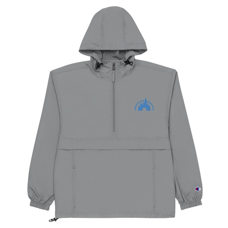 May include: A grey hooded windbreaker with a blue embroidered castle logo on the front. The jacket has a zip closure and a drawstring at the bottom.