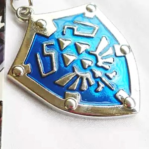 The Legend of Zelda Necklace, Keychain pendant, Zelda Locket Hylian Shield pendant, Anniversary gift, Clothing decor Pendant