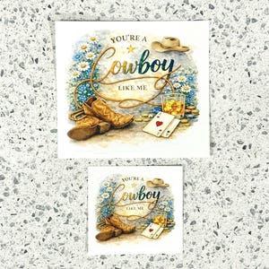 May include: A cowboy-themed print with the text "You're a Cowboy Like Me." The image features cowboy boots, a hat, playing cards, and a glass of amber liquid. The design includes a floral arrangement and gold accents.