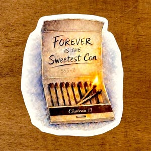 May include: A sticker featuring a matchbox design with the text "FOREVER IS THE Sweetest Con" and "Chateau 13". The matchbox is open, with several matches and a lit match with a flame.