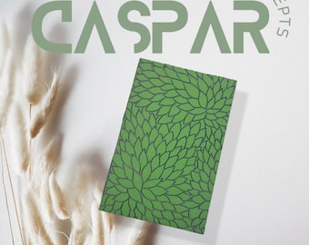 以下が含まれることがあります： 黒と白の花柄がついた緑色のノート。ノートには「CASPAR Concepts」というタイトルと「Australian Copyright Council 2023 under the Copyright Act 1968」というテキストが書かれています。