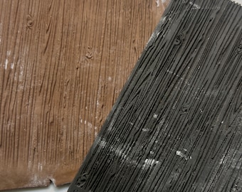 May include: A brown fondant sheet with a wood grain texture, being pressed into a black silicone mold with the text "CASPAR Concepts".