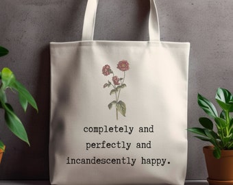 May include: A white canvas tote bag with a floral design and the text "completely and perfectly and incandescently happy."