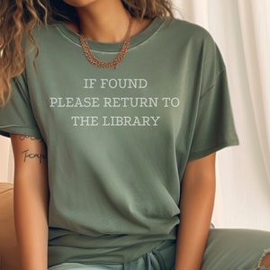 May include: A green t-shirt with the text "IF FOUND PLEASE RETURN TO THE LIBRARY" printed on the front.