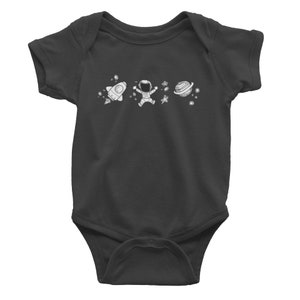 May include: A dark gray baby onesie with a white astronaut, rocket, and planet design.