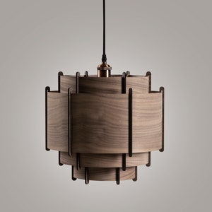 May include: A wooden pendant light with a layered, geometric design. The light fixture is made of multiple pieces of wood that are stacked on top of each other to create a unique and modern look.