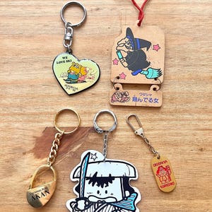 80年代の日本のヴィンテージかわいいスキーベアカップル、魔女、ロック、サムライ、桃太郎キャラクターのお土産キーチェーン、5個