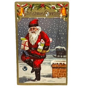 Carte postale de voeux de Noël ancienne avec le Père Noël tenant des cadeaux dans ses bras
