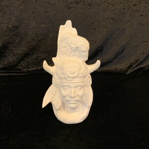 May include: White ceramic figurine of a Native American man wearing a headdress with feathers. The figurine is a blank canvas ready to be painted.