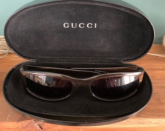 Vintage 1990's 2526 Gucci green tortoise shell effect sunglasses, with original leather covered case and information leaflet.