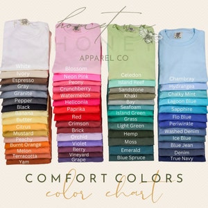Op de afbeelding: Een kleurenkaart met vier verticale stapels gevouwen t-shirts in diverse tinten. De tekst luidt Hometown Honey Apparel Co en Comfort Colors color chart, met labels voor elke kleur, waaronder White, Ivory, Espresso, Gray, Granite, Pepper, Black, Banana, Butter, Citrus, Mustard, Peachy, Burnt Orange, Melon, Terracotta, Yam, Blossom, Neon Pink, Peony, Crunchberry, Watermelon, Heliconia, Paprika, Red, Crimson, Brick, Orchid, Violet, Berry, Vineyard, Grape, Celedon, Island Reef, Sandstone, Khaki, Bay, Seafoam, Island Green, Grass, Light Green, Hemp, Moss, Emerald, Blue Spruce, Chambray, Hydrangea, Chalky Mint, Lagoon Blue, Sapphire, Flo Blue, Periwinkle, Washed Denim, Ice Blue, Blue Jean, Denim en True Navy.