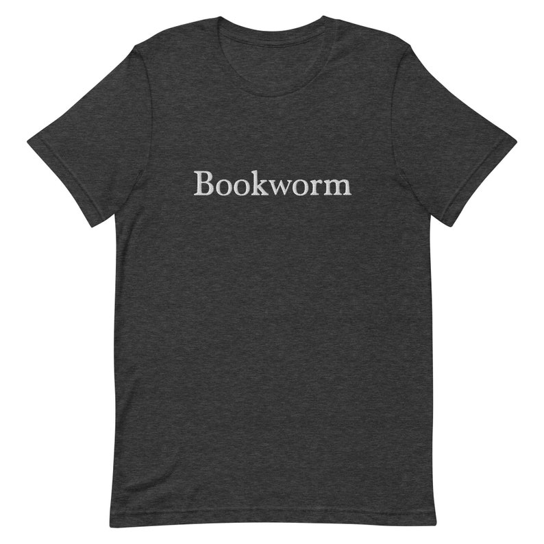 May include: Dark heather grey t-shirt with the word "Bookworm" printed in white on the front.