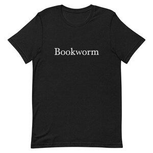 May include: Black t-shirt with the word "Bookworm" printed in white on the front.