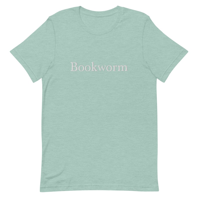 May include: A light blue t-shirt with the word "Bookworm" printed in white on the front.