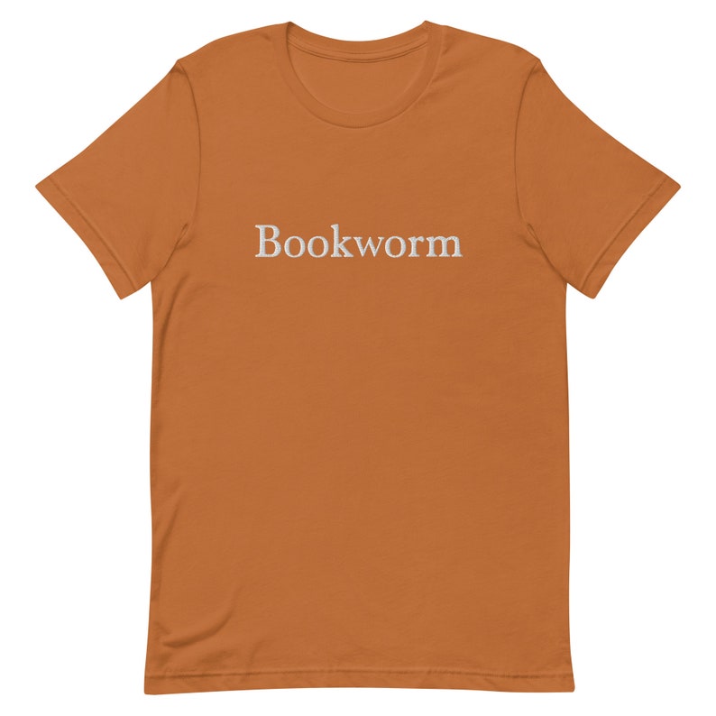 May include: A brown t-shirt with the word "Bookworm" embroidered in white on the front.