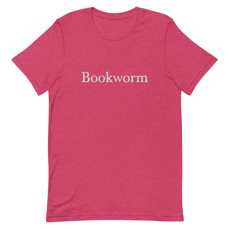 May include: A pink heather t-shirt with the word "Bookworm" printed in white on the front.
