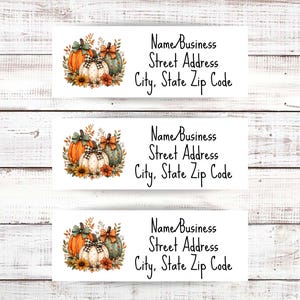 May include: Three rectangular address labels featuring a watercolor illustration of three pumpkins with bows and sunflowers. The text reads Name/Business, Street Address, and City, State Zip Code in a black script font on a white background.