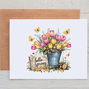 May include: A greeting card with a floral illustration of pink and yellow tulips in a blue bucket with butterflies and a sign that says "hello spring".