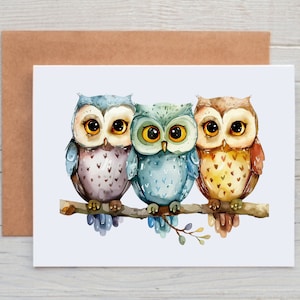 May include: Three watercolor owls perched on a branch. The owl on the left is purple and blue, the middle owl is blue and green, and the owl on the right is brown and yellow.