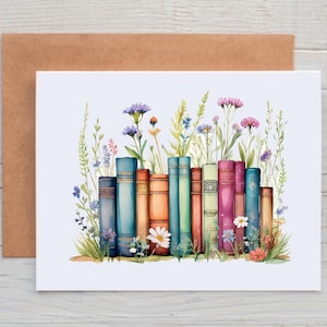 May include: A watercolor painting of a stack of colorful books with wildflowers growing around them. The books are arranged in a row and have different colors and patterns. The wildflowers are in shades of blue, purple, pink, and yellow.