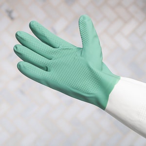 May include: A green rubber cleaning glove with a white cuff. The glove has a textured surface for a better grip.