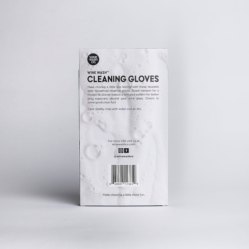 May include: A white package with black text that reads "WINE WASH" and "CLEANING GLOVES". The package features a textured pattern and the text "Make choring a little less boring with these reusable latex household cleaning gloves. Sized medium for a flexible fit. Gloves feature a textured pattern for better grip, especially around your wine glass. Cheers to some good clean fun! Care: Gently rinse with water and air dry."