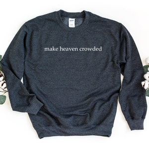 May include: A dark gray sweatshirt with the text "make heaven crowded" printed in white on the front.