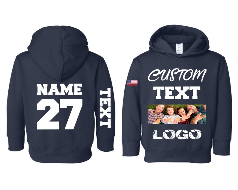 May include: A navy blue hooded sweatshirt with a white American flag on the left sleeve. The front of the sweatshirt has the text "CUSTOM TEXT" and a photo of a family. The back of the sweatshirt has the text "NAME 27" and the text "TEXT" on the right sleeve.