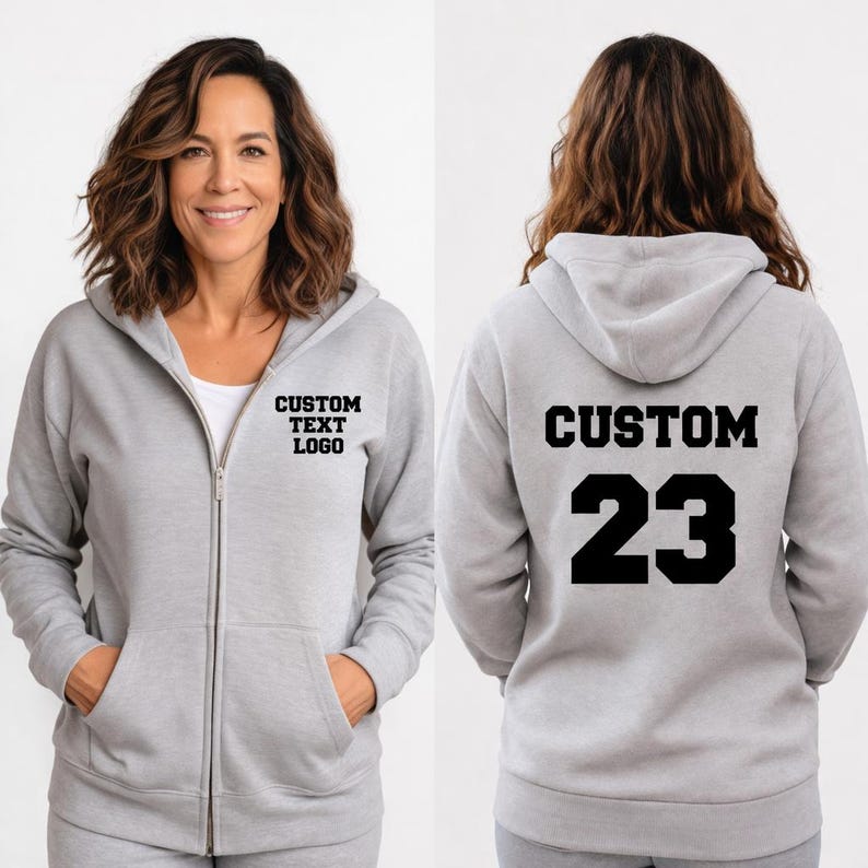 A woman wearing a grey hooded sweatshirt with the text "CUSTOM TEXT LOGO" and the number "23" printed on the back.