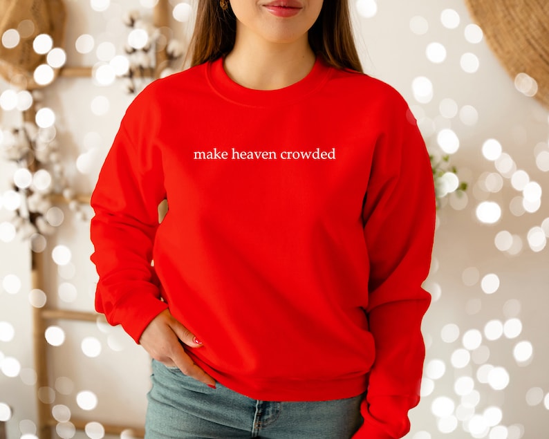 May include: Red sweatshirt with the text "make heaven crowded" in white.
