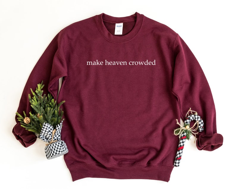 May include: Burgundy sweatshirt with the text "make heaven crowded" in white lettering.