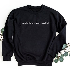 May include: Black sweatshirt with the text "make heaven crowded" printed in white on the front.