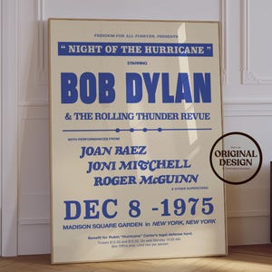 May include: A vintage-style poster with a cream background and blue text. The poster promotes a Bob Dylan concert, "Night of the Hurricane," featuring Joan Baez and Joni Mitchell. The concert date is December 8, 1975, at Madison Square Garden.