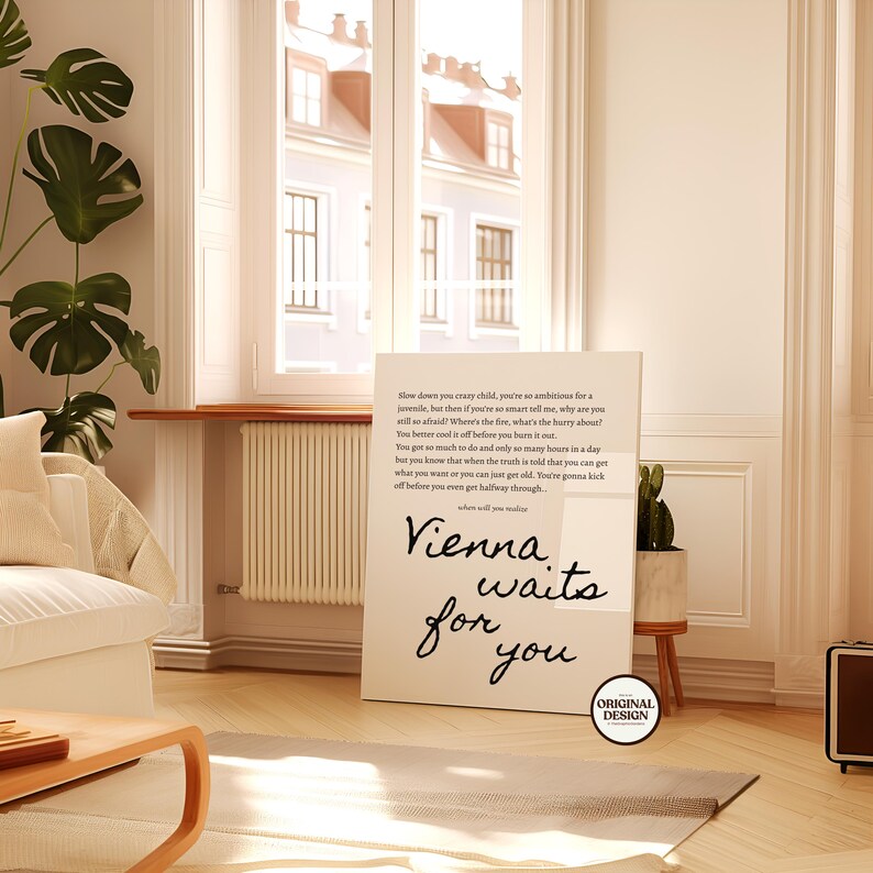 May include: A rectangular canvas print with the text "Vienna waits for you" in a cursive font. The print also features a poem. The canvas is displayed in a bright, airy room with a window and wooden floors.