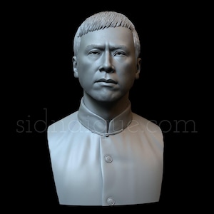 May include: A gray bust sculpture of a man with short hair. The man is wearing a collared shirt with a mandarin collar.