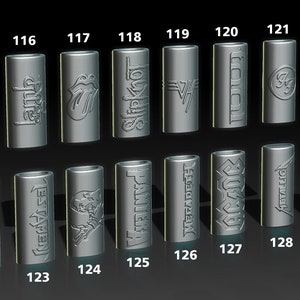 May include: A set of 15 silver metal guitar picks with various band logos, including Skynyrd, Guns N' Roses, Metallica, and Anthrax. The picks are numbered 115 through 129.