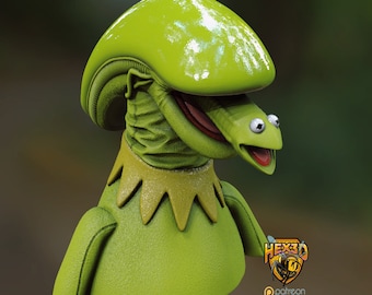May include: A green puppet with a large, round head and a wide, open mouth. The puppet has a textured, scaly skin and a large, round nose. The puppet is wearing a green collar with a white trim. The puppet's eyes are large and round, and its mouth is open in a wide grin. The puppet is looking to the right. The text "HEX3D" and "patreon.com/geoffro" is visible in the image.
