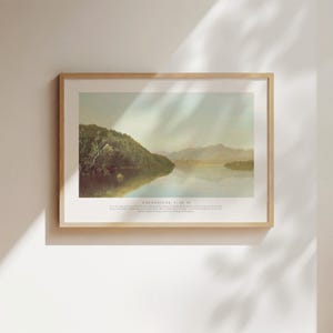 Könnte beinhalten: Ein gerahmter Landschaftsdruck mit einer ruhigen See-Szene, grünen Hügeln und Bergen im Hintergrund. Das Kunstwerk hat eine sanfte Farbpalette und enthält den Text "COLOSSER 1:16-17" am unteren Rand.