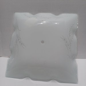 May include: White glass ceiling light fitting with a square shape and a scalloped edge. The glass has a subtle etched design of wheat stalks.