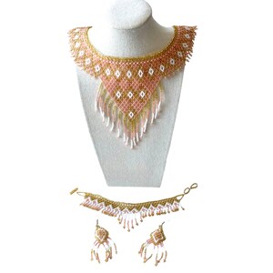 May include: A beaded jewelry set featuring a necklace, bracelet, and earrings. The necklace is displayed on a mannequin and has a pink, gold, and white geometric design. The bracelet and earrings mirror the necklace's design.
