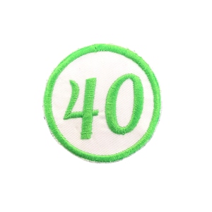 May include: A white circle with a green border and the number 40 embroidered in green.