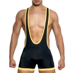 May include: Black wrestling singlet with yellow trim. The singlet features a scoop neck and shoulder straps, with yellow accents along the edges. The garment is form-fitting and made of a shiny material.